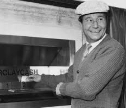 Reg Varney makes a withdrawal from an ATM